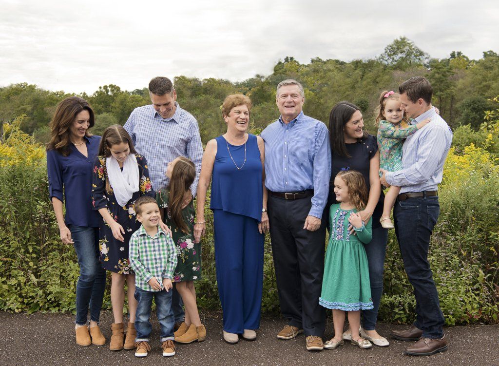 big family laughing at the park