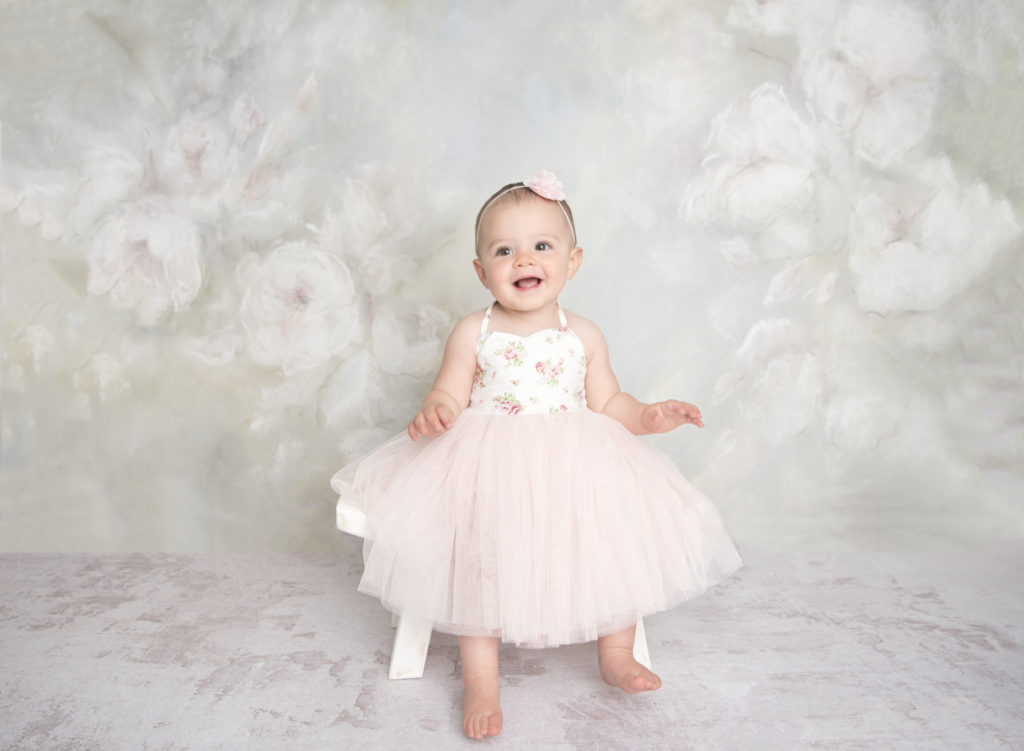 first_birthday_portrait_session_baby_girl_cake_smash_floral_backdrop_studio_lansdale_photographer