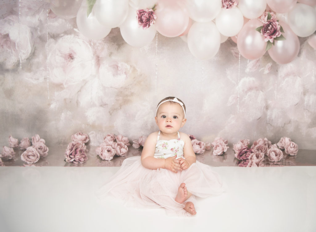 first_birthday_portrait_session_baby_girl_cake_smash_floral_backdrop_studio_lansdale_photographer