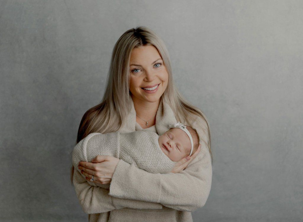mom_holding_newborn_baby_girl_cream_studio_gray_cream_lansdale_newborn