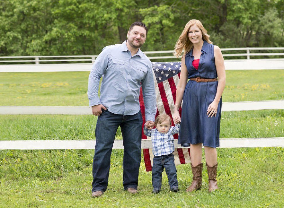 family-with-little-boy-in-front-of-american-flag