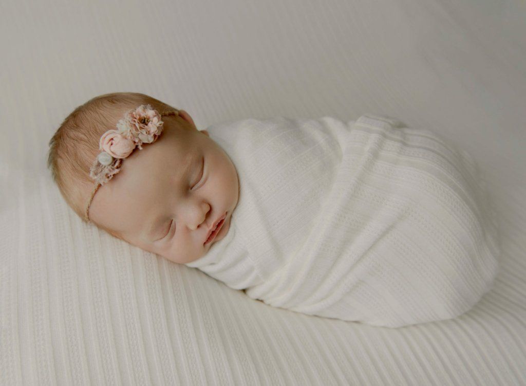 newborn_baby_girl_sleeping_cream_blanket_pink_headband_lansdale_newborn_baby