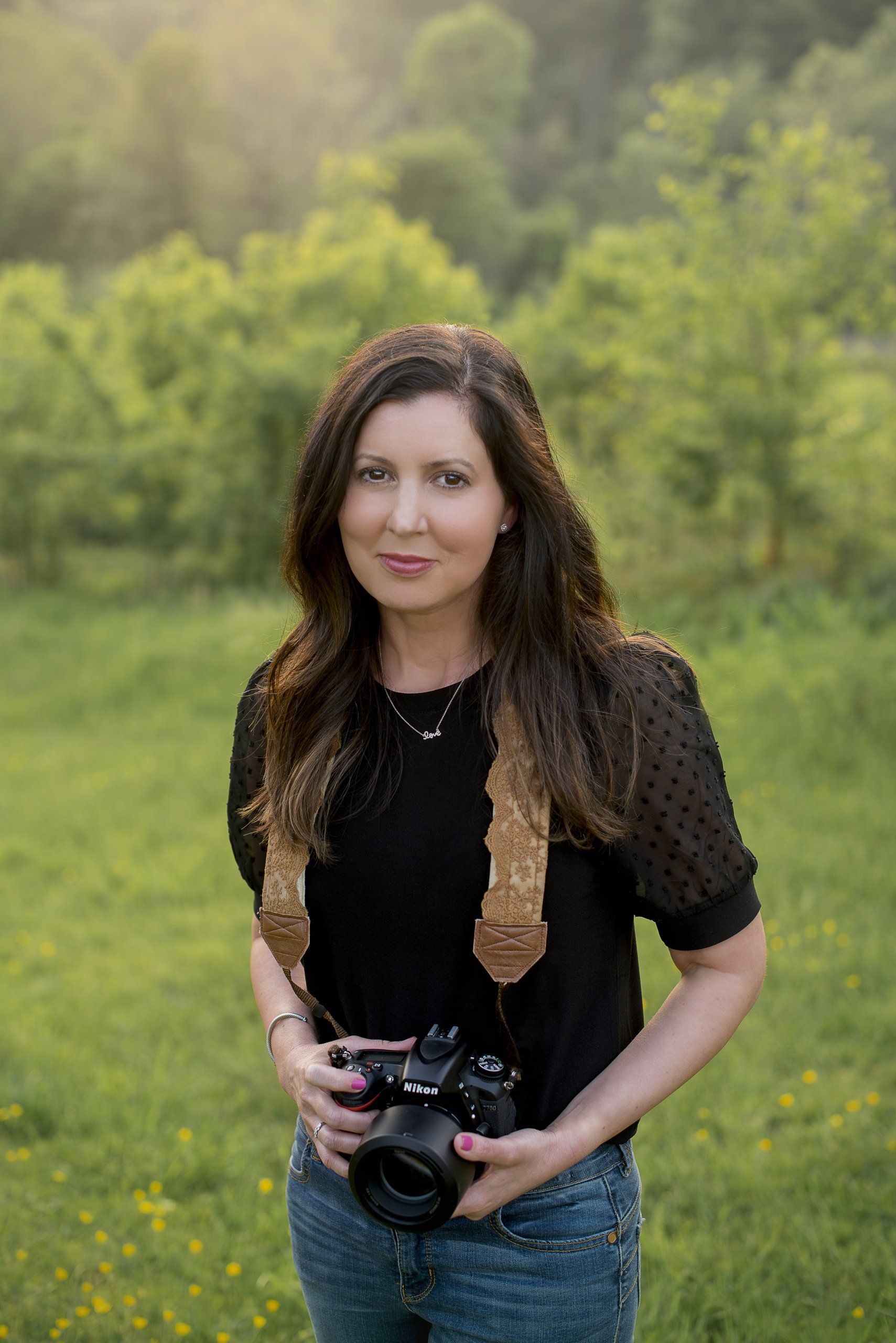lori maguire standing with the camera in the field