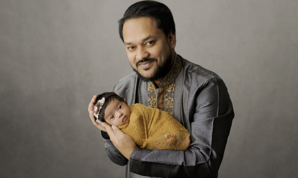dad holding newborn baby girl Lansdale Family and Newborn Photographer
