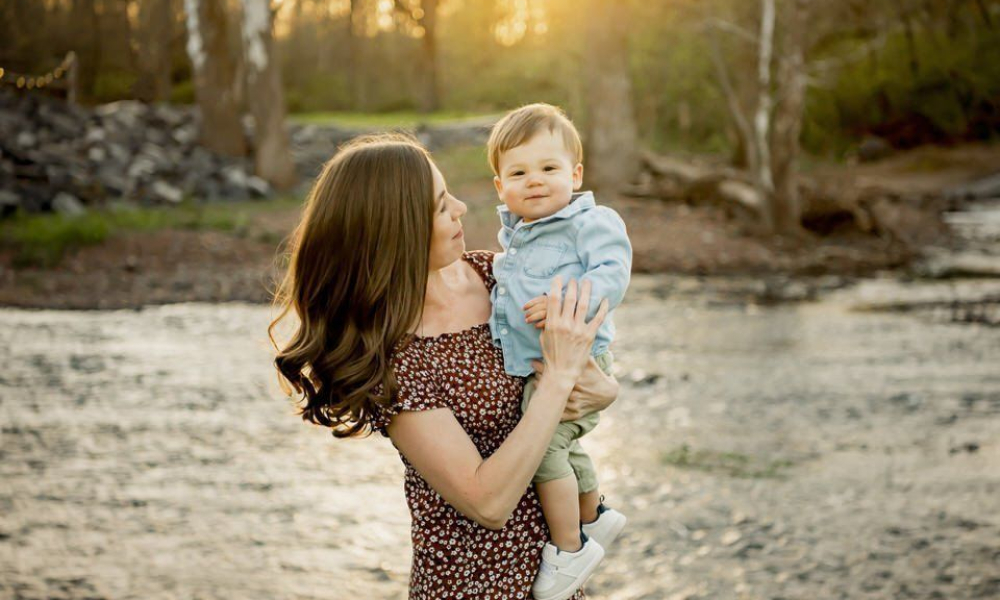 Mom holding son at sunset by the creek at Fischers Park - Lansdale family and newborn photographer.