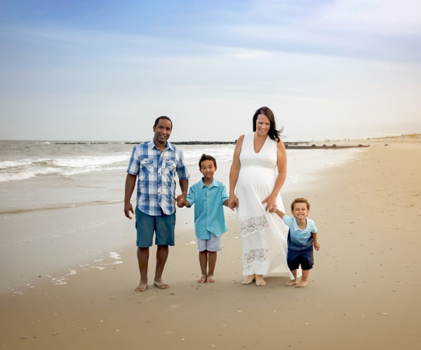 husband and pregnant wife with their children on Ocean City, beach Lansdale family and newborn photographer