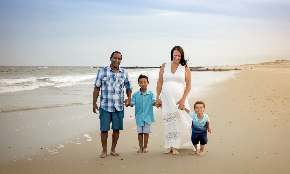 husband and pregnant wife with their children on Ocean City, beach Lansdale family and newborn photographer