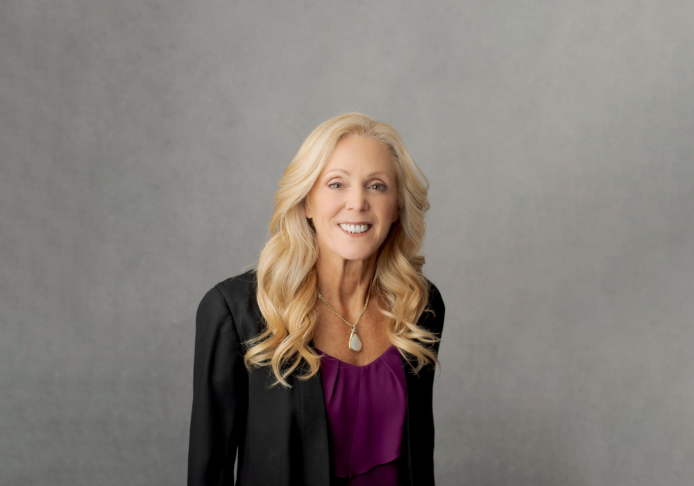 Professional headshot woman wearing black jacket with purple shirt Lansdale