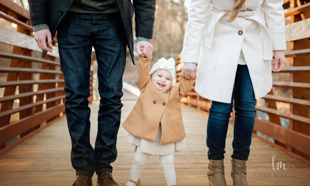 A couple with their baby girl on the bridge Fischers Park Lansdale