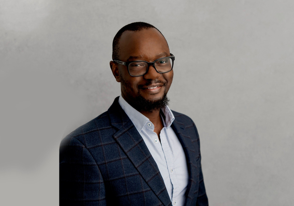 Professional headshot of man wearing white dotted shirt and blue checked suite jacket Lansdale