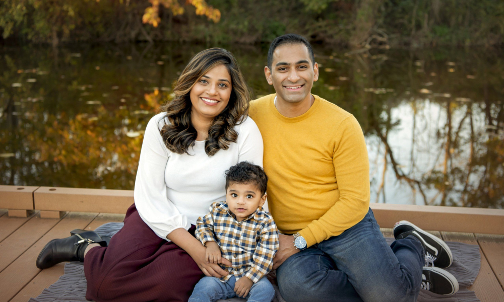 Men and Women sitting on the ground with their boy