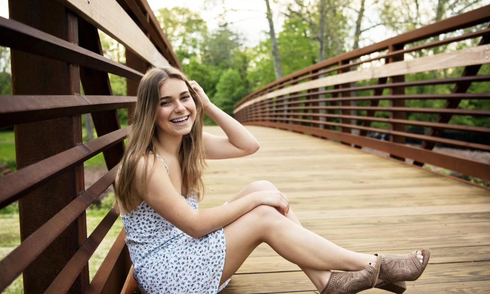 High School Senior sitting on the bridge at Fischers Park in Lansdale Lansdale family and newborn photographer