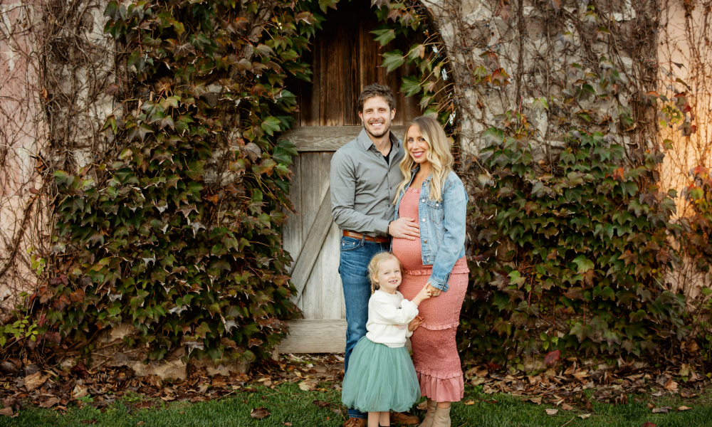 Man with his pregnant wife and daughter