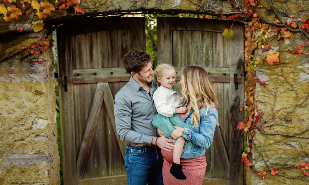 Pregnant Mom withDad laughing with their daughter at the highland mansion in Ft. Washington