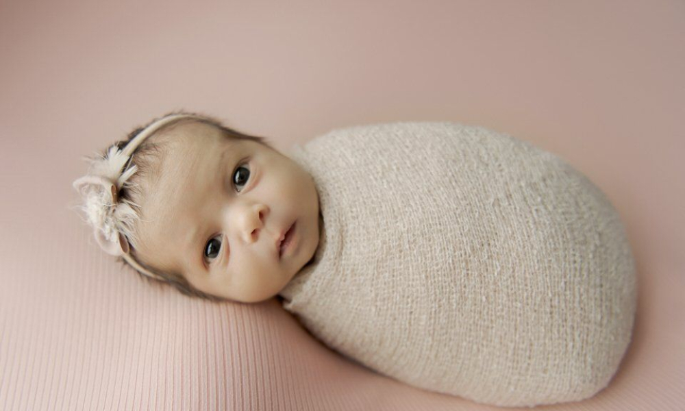 Newborn baby looking at the camera