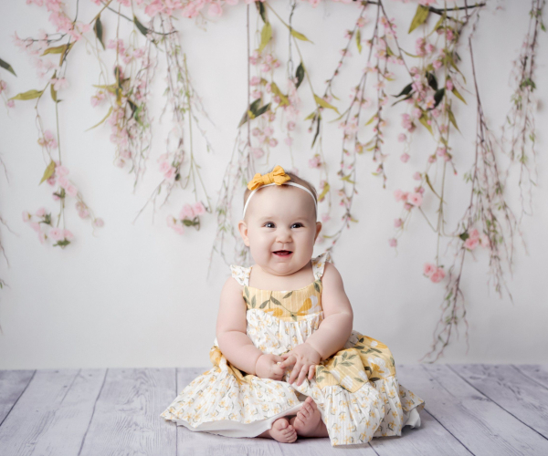 six month old milestone baby sitting session yellow and white dress pink flowers Lansdale family and newborn photographer