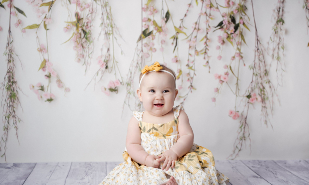 six month old milestone baby sitting session yellow and white dress pink flowers Lansdale family and newborn photographer